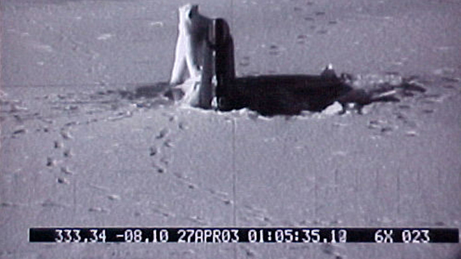 Apr. 27, 2003: A polar bear approaches the tail of the USS Connecticut, a Sea Wolf-class nuclear submarine, after it surfaced through ice in the Arctic Ocean. The photo was taken through the periscope of the submarine, which was on exercises in the Arctic. (AP PHOTO/U.S. NAVY) via Fox News -  click 